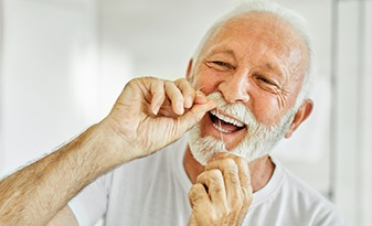The day-to-day benefits of dental implants include easier care and maintenance like brushing and flossing