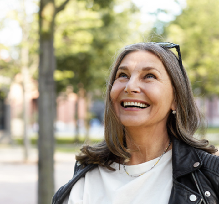 Senior woman walking outside and smiling